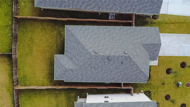 an aerial view of residential house with a yard