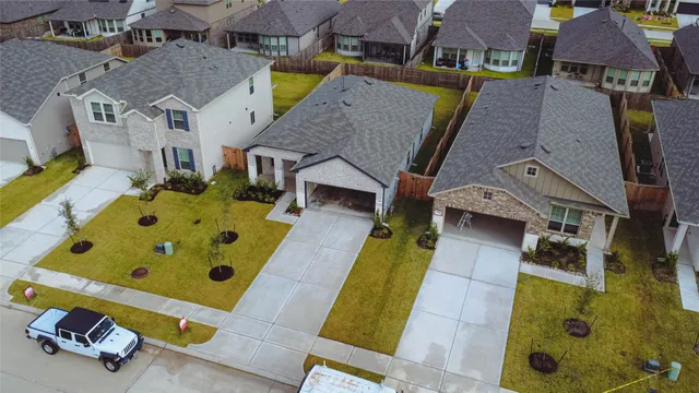an aerial view of residential houses with outdoor space