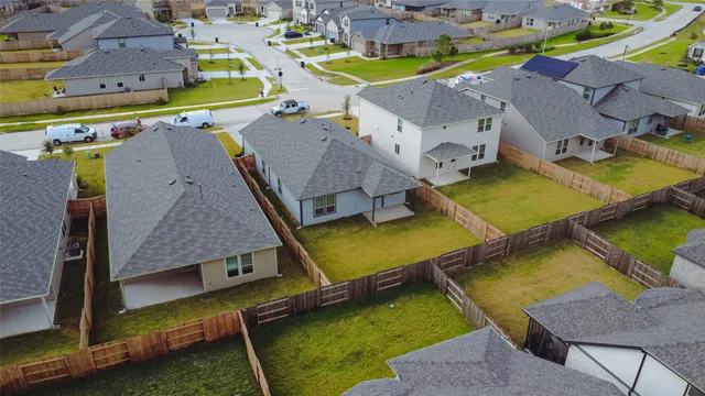 an aerial view of a pool with a garden