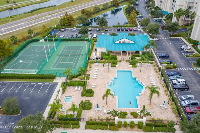 a view of swimming pool with outdoor seating and city view
