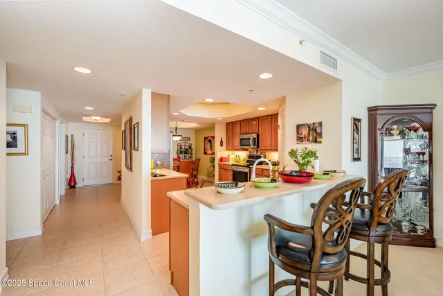 a kitchen with stainless steel appliances granite countertop sink stove refrigerator and cabinets