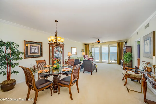 a living room with dining table and chairs