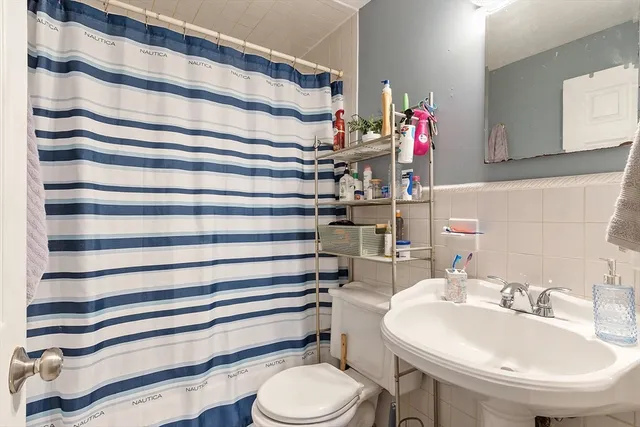 a bathroom with a sink toilet and a mirror