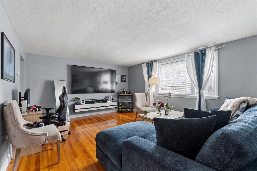 10 Everett Avenue Boston, MA 02125 - Photo 23 of 42 a living room with furniture and a flat screen tv