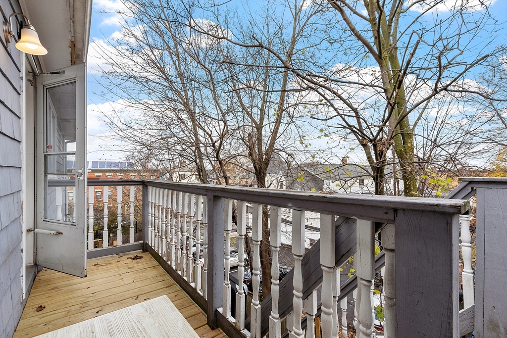 10 Everett Avenue Boston, MA 02125 - Photo 7 of 42 a view of a pathway of a house with wooden fence and floor