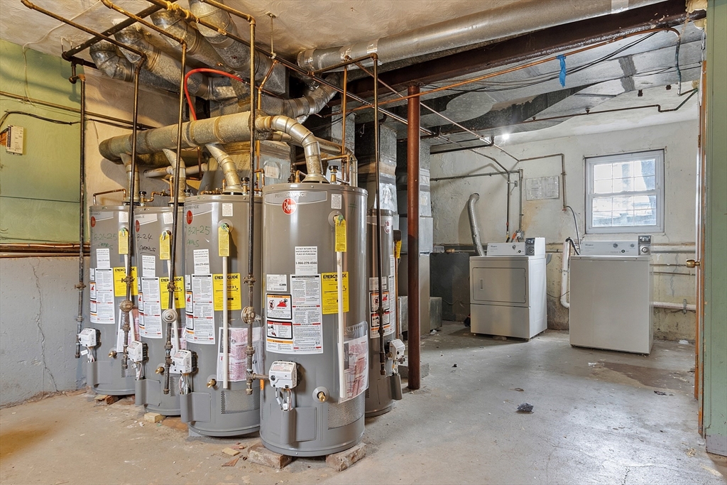 10 Everett Avenue Boston, MA 02125 - Photo 9 of 42 a view of a storage room with water heater and windows