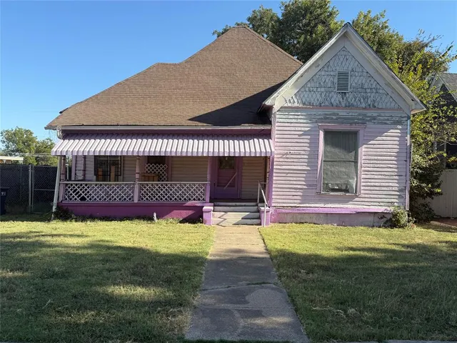 a view of a house with a yard and sitting area