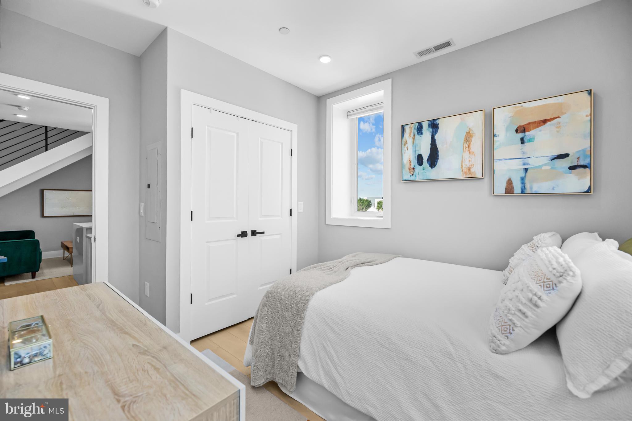 1915 H Street Northeast, Unit PH1 Washington, DC 20002 - Photo 4 of 21 a bedroom with a bed and a painting on the wall