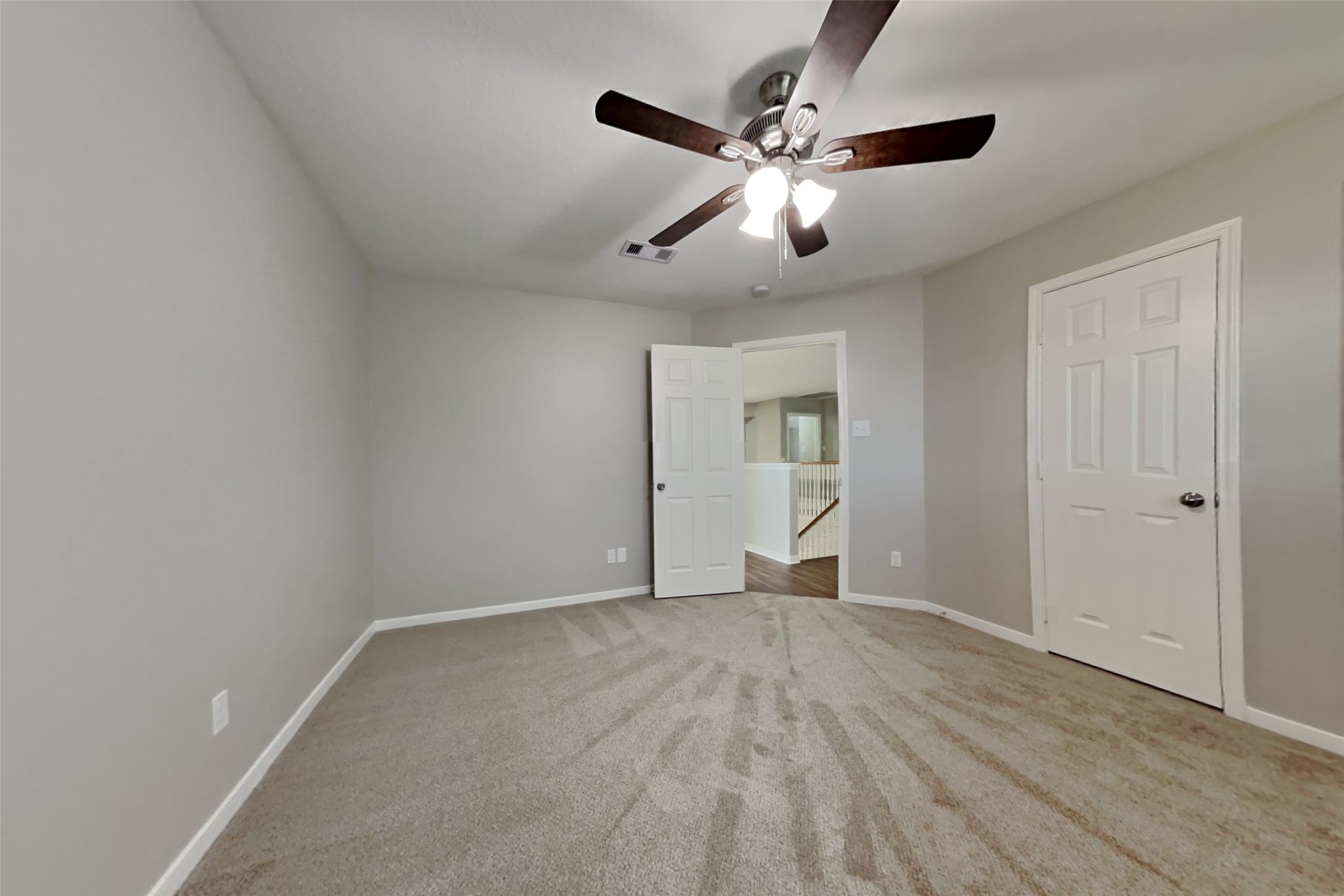 3242 Enchanted Hollow Lane Spring, TX 77388 - Photo 14 of 24 a view of an empty room with wooden floor and a ceiling fan