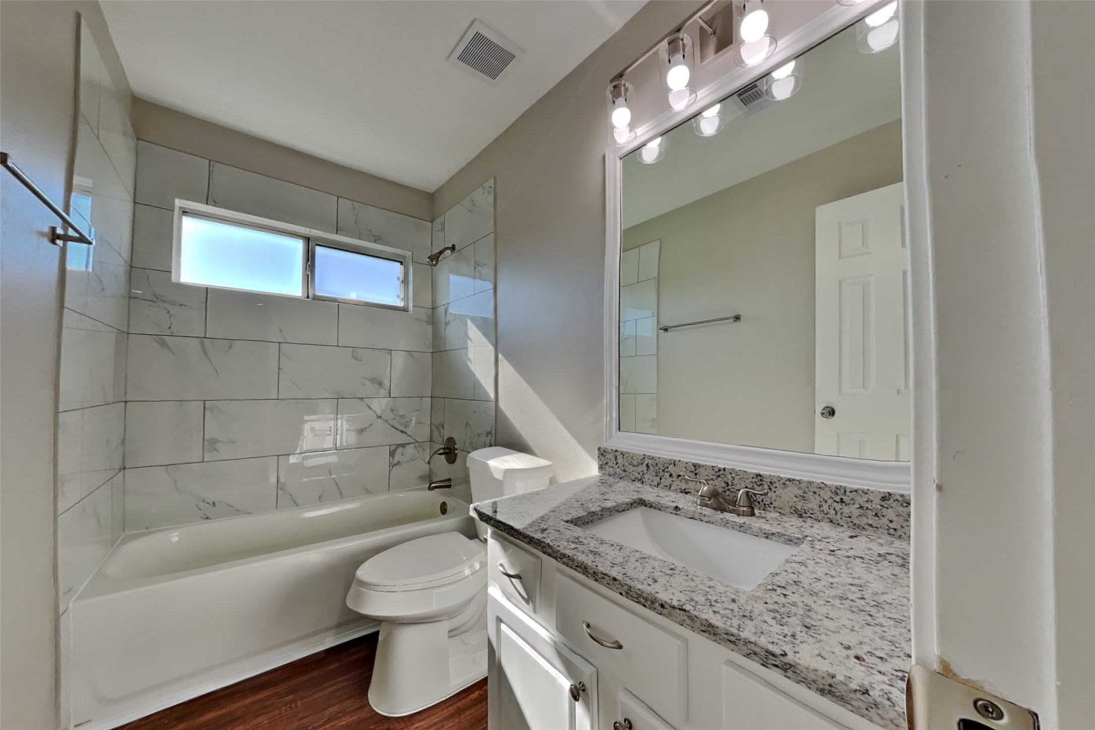3242 Enchanted Hollow Lane Spring, TX 77388 - Photo 18 of 24 a bathroom with a granite countertop sink a toilet a mirror and bathtub