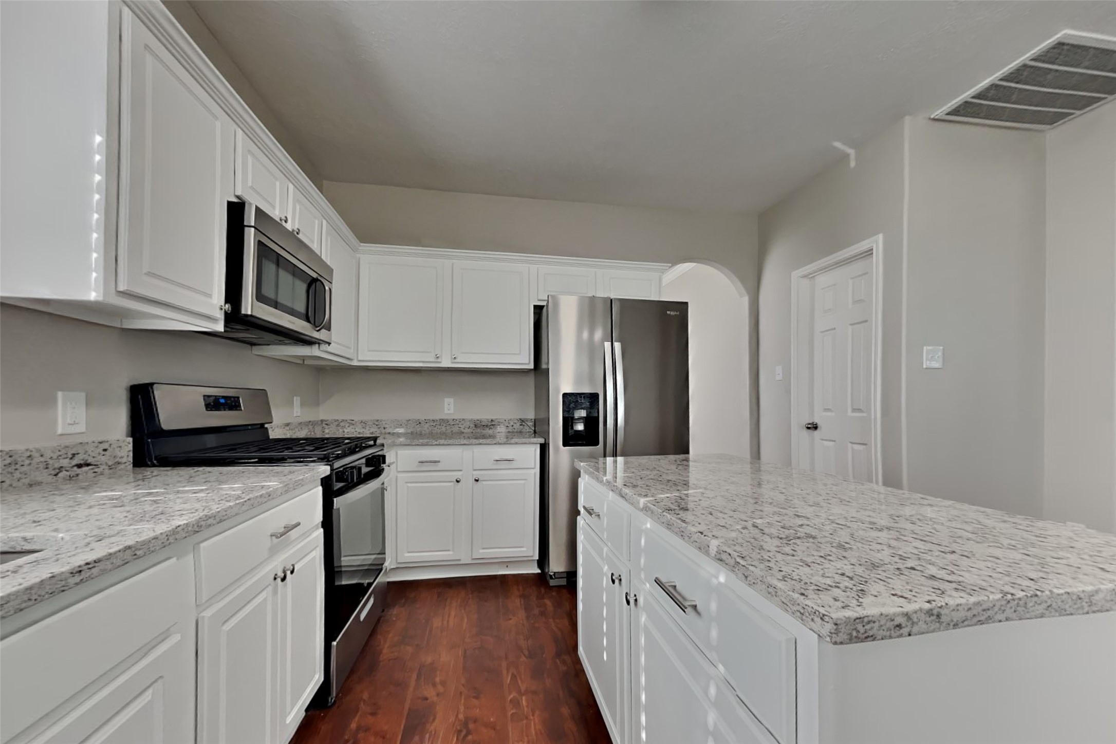 3242 Enchanted Hollow Lane Spring, TX 77388 - Photo 9 of 24 a kitchen with stainless steel appliances granite countertop a stove top oven a refrigerator a sink and dishwasher with wooden floor