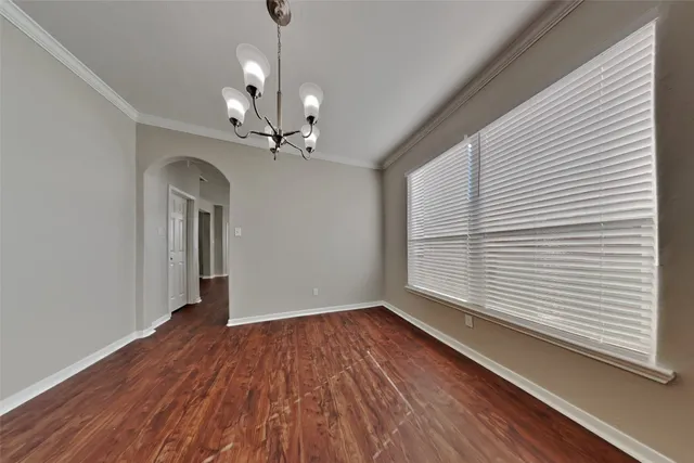 a view of a livingroom with wooden floor and a ceiling fan