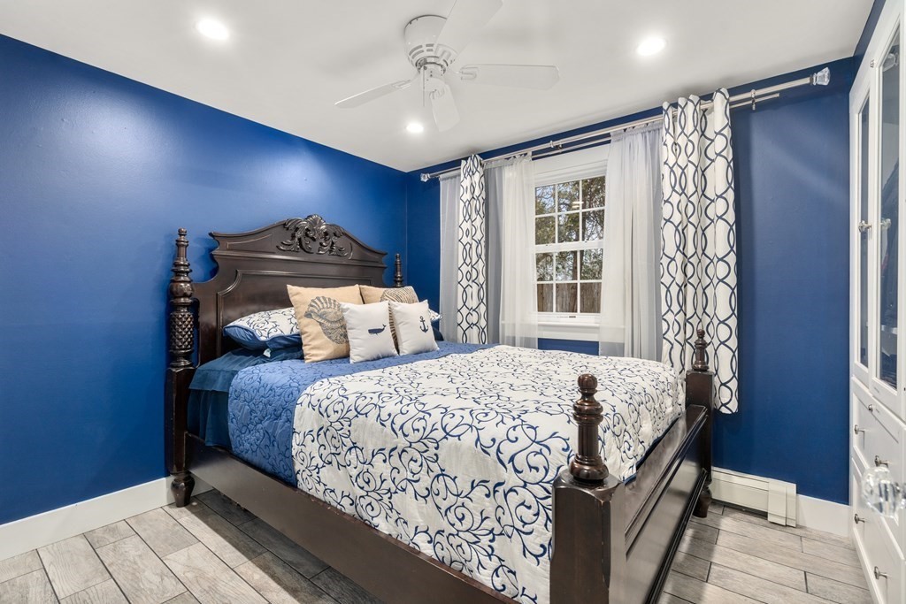 558 Craigville Beach Road, Unit 8 Barnstable, MA 02632 - Photo 3 of 10 a bed sitting in a spacious bedroom next to a window
