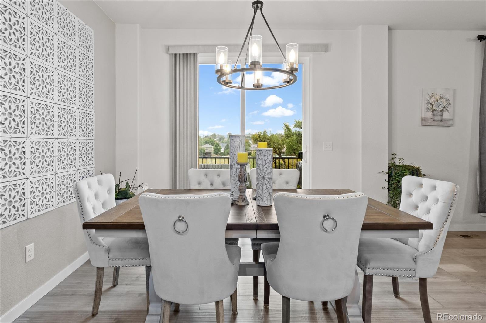 6302 2nd Street Greeley, CO 80634 - Photo 13 of 37 a view of a dining room with furniture wooden floor and chandelier