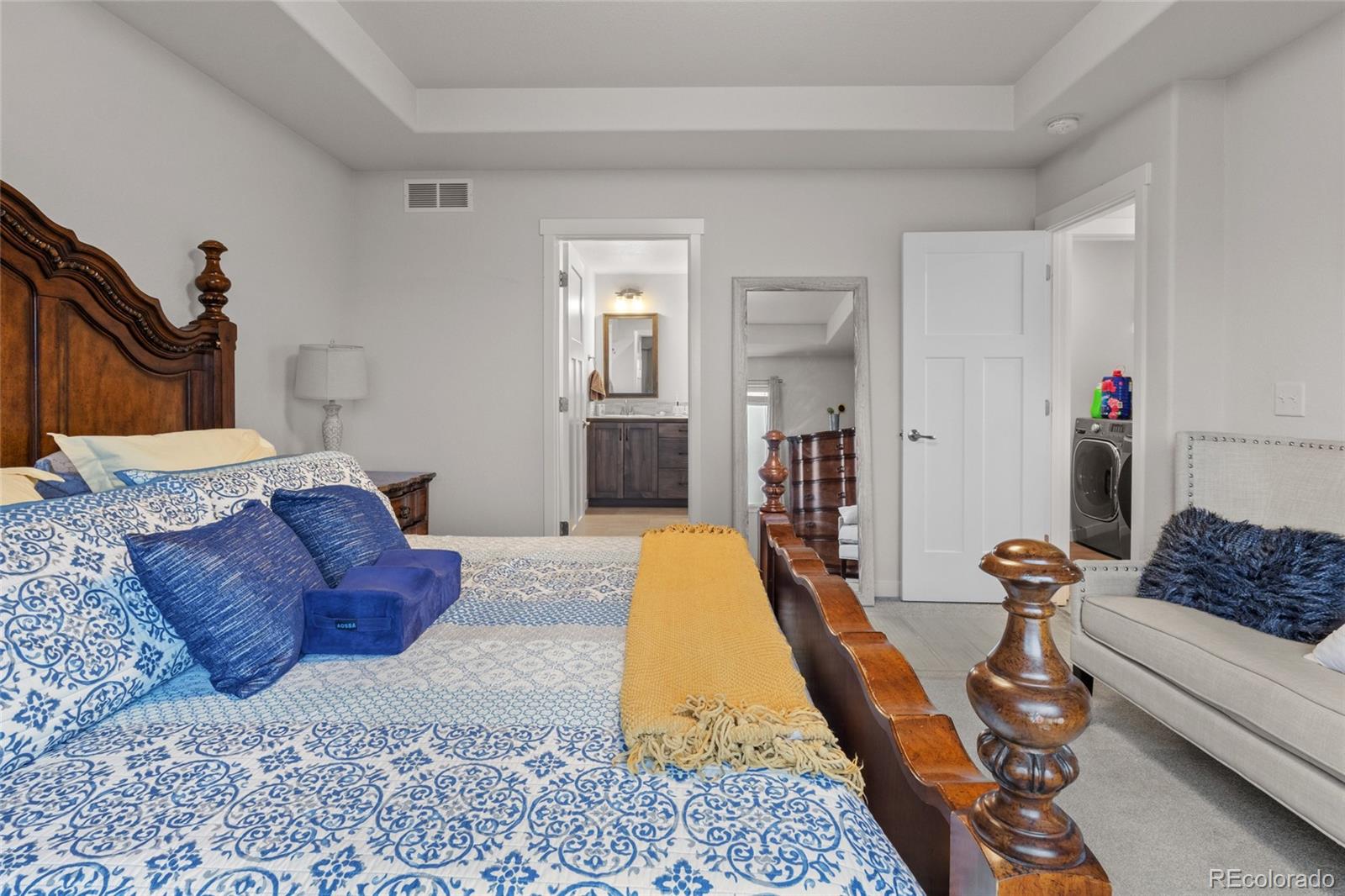 6302 2nd Street Greeley, CO 80634 - Photo 19 of 37 a spacious bedroom with a bed a couch and dresser