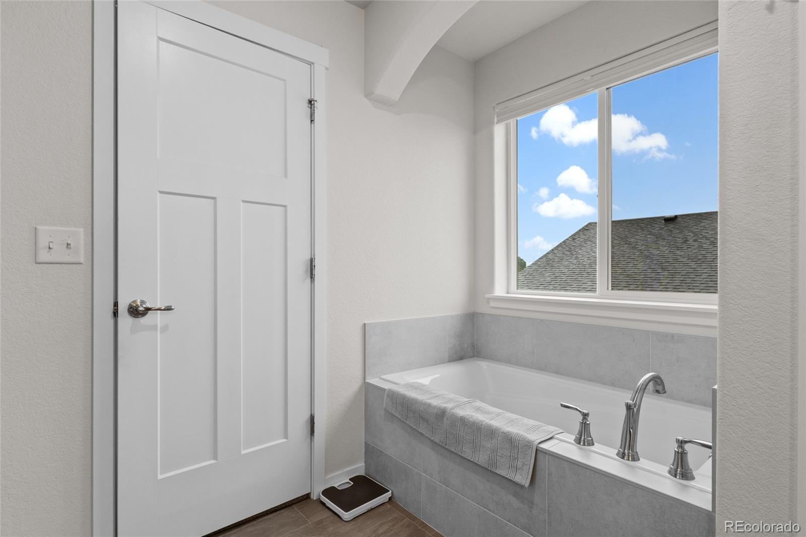 6302 2nd Street Greeley, CO 80634 - Photo 21 of 37 a bathroom with a bathtub and window