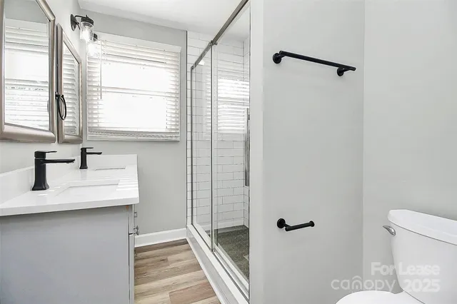 a bathroom with a sink toilet and shower