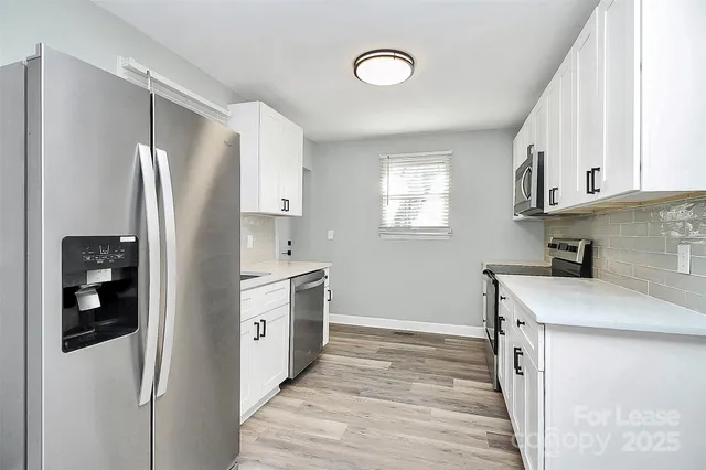 a kitchen with granite countertop a refrigerator and a sink