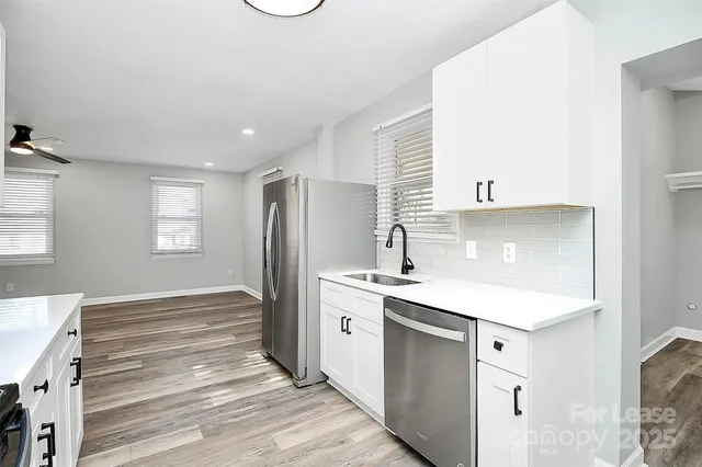 a kitchen with a sink stove and refrigerator