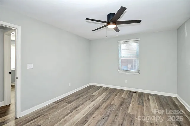 a view of a big room with wooden floor closet and windows