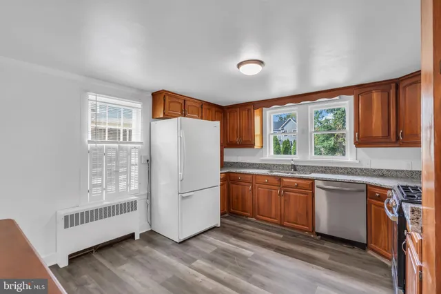 a kitchen with stainless steel appliances granite countertop a stove and a microwave