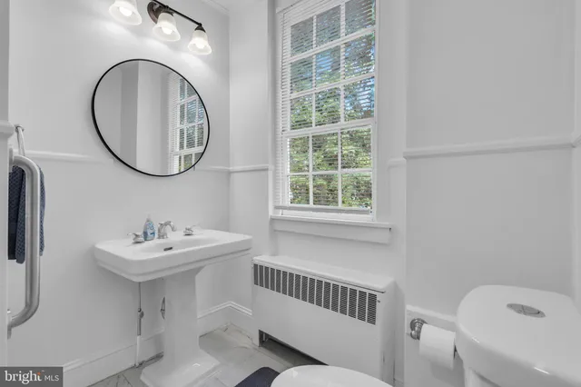 a bathroom with a shower sink and mirror