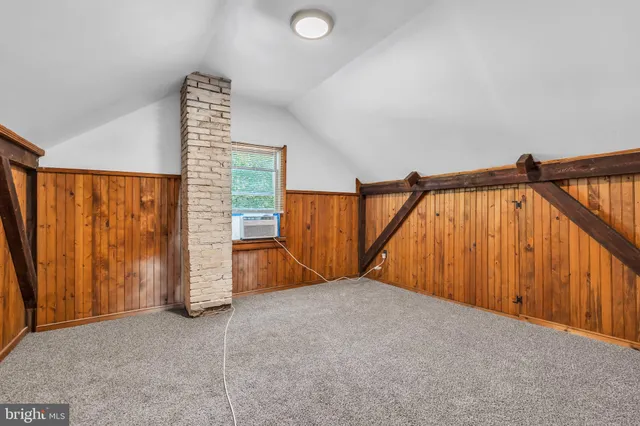 a view of an empty room with wooden walls