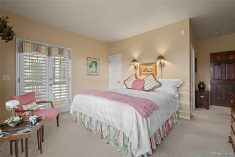 a bedroom with a bed chair and window