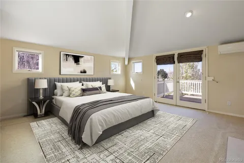 a spacious bedroom with a large bed and a window
