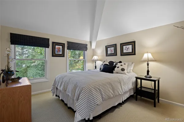 a bedroom with a bed and a large window
