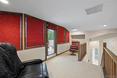 a living room with furniture gym equipment and a window