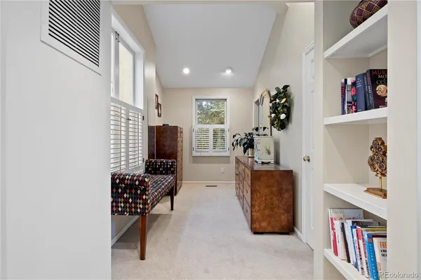 a living room with furniture and a book shelf