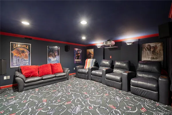 a media room with lots of chairs and a projector