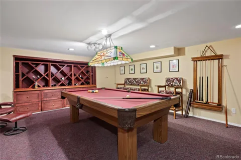 a room with furniture and pool table