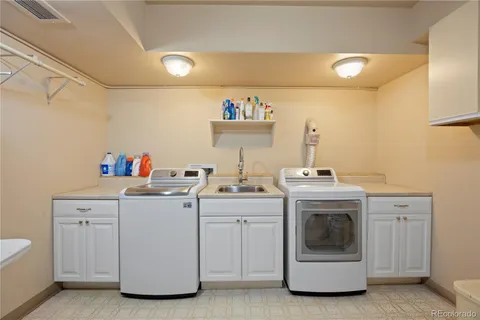 a utility room with sink dryer and washer