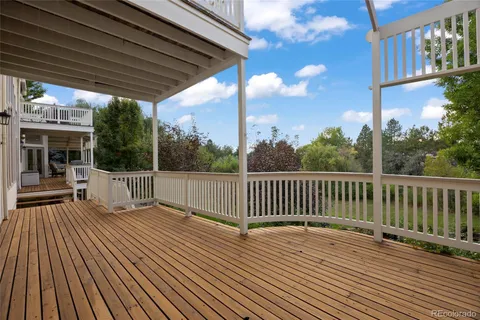 a view of house with deck outdoor seating and barbeque