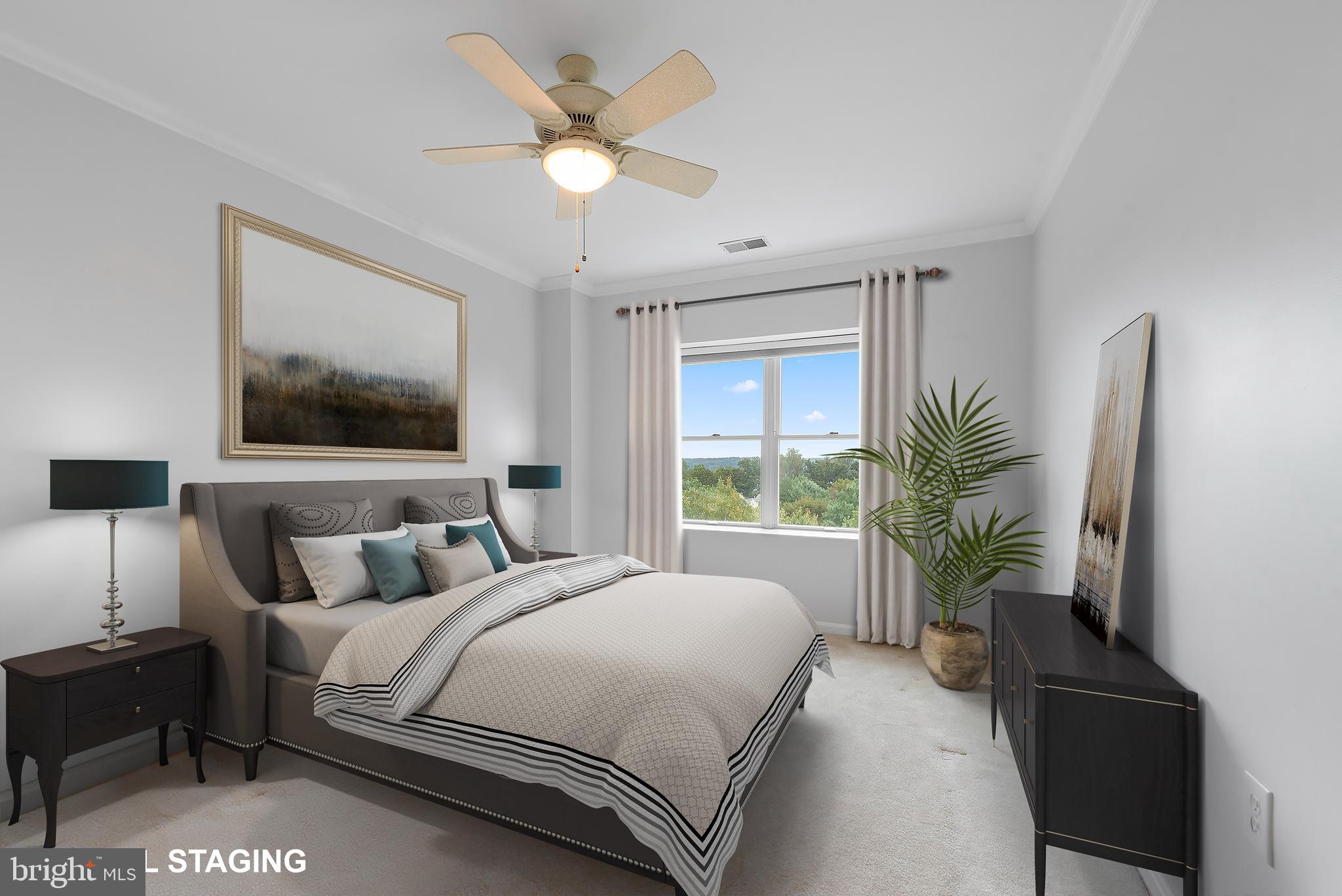 12240 Roundwood Road, Unit 704 Lutherville-Timonium, MD 21093 - Photo 15 of 22 a bedroom with a bed and a chandelier