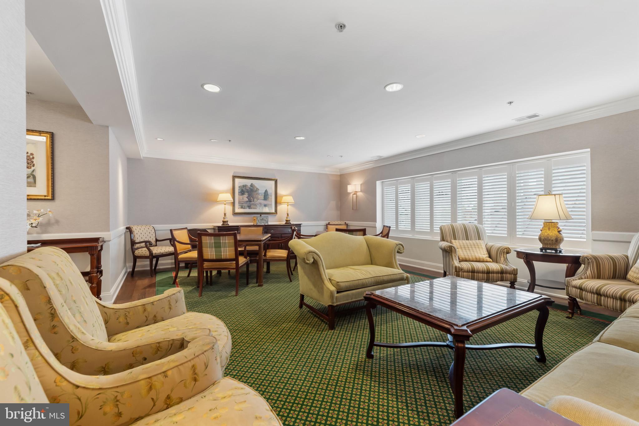 12240 Roundwood Road, Unit 704 Lutherville-Timonium, MD 21093 - Photo 21 of 22 a living room with furniture and a table