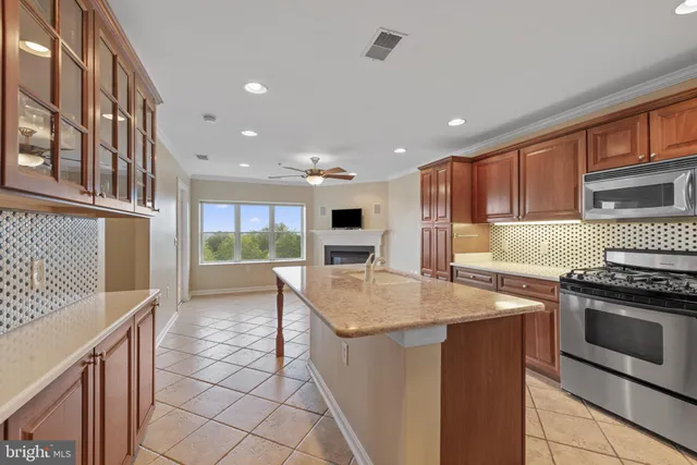 a kitchen with stainless steel appliances granite countertop a stove and a sink