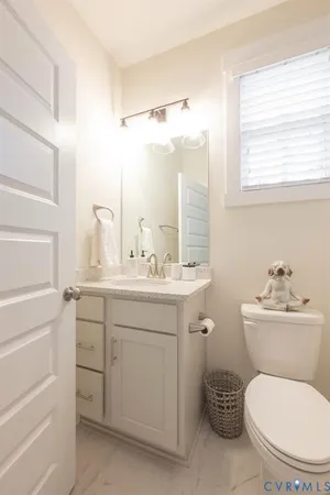 a bathroom with a toilet a sink and a mirror
