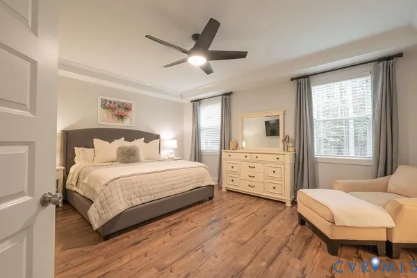 a bedroom with a large bed and a flat tv screen