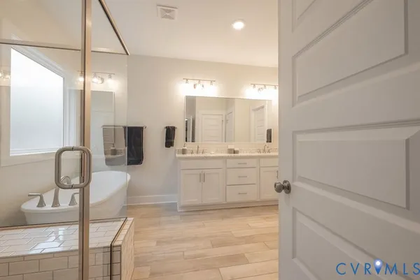 a bathroom with a double vanity sink and mirror