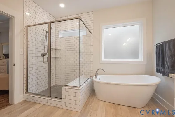 a bathroom with a granite countertop sink mirror and bathtub
