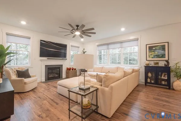 a living room with furniture fireplace and a flat screen tv