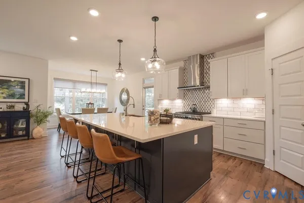 a kitchen with center island white cabinets and stainless steel appliances