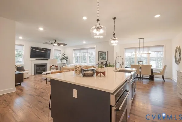a large kitchen with a counter space a sink appliances and a dining table