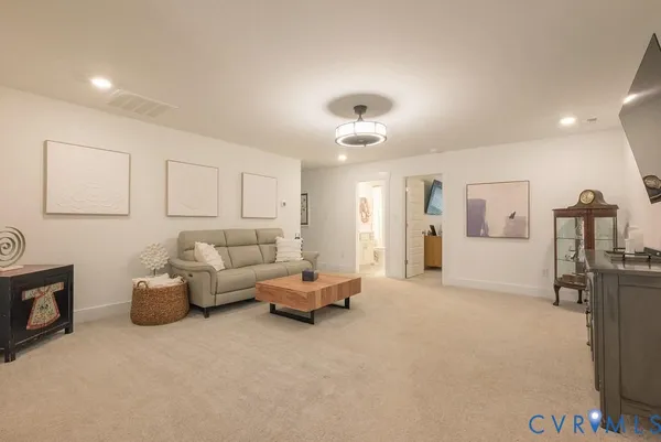 a living room with furniture and white walls