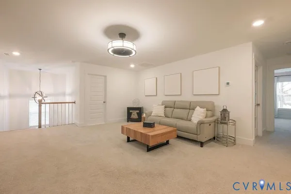 a living room with furniture and a chandelier
