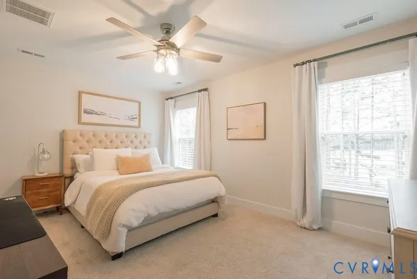 a bedroom with a large bed and a window