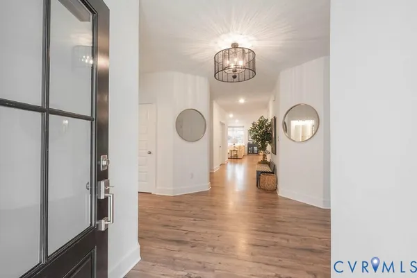 an empty room with wooden floor and mirror
